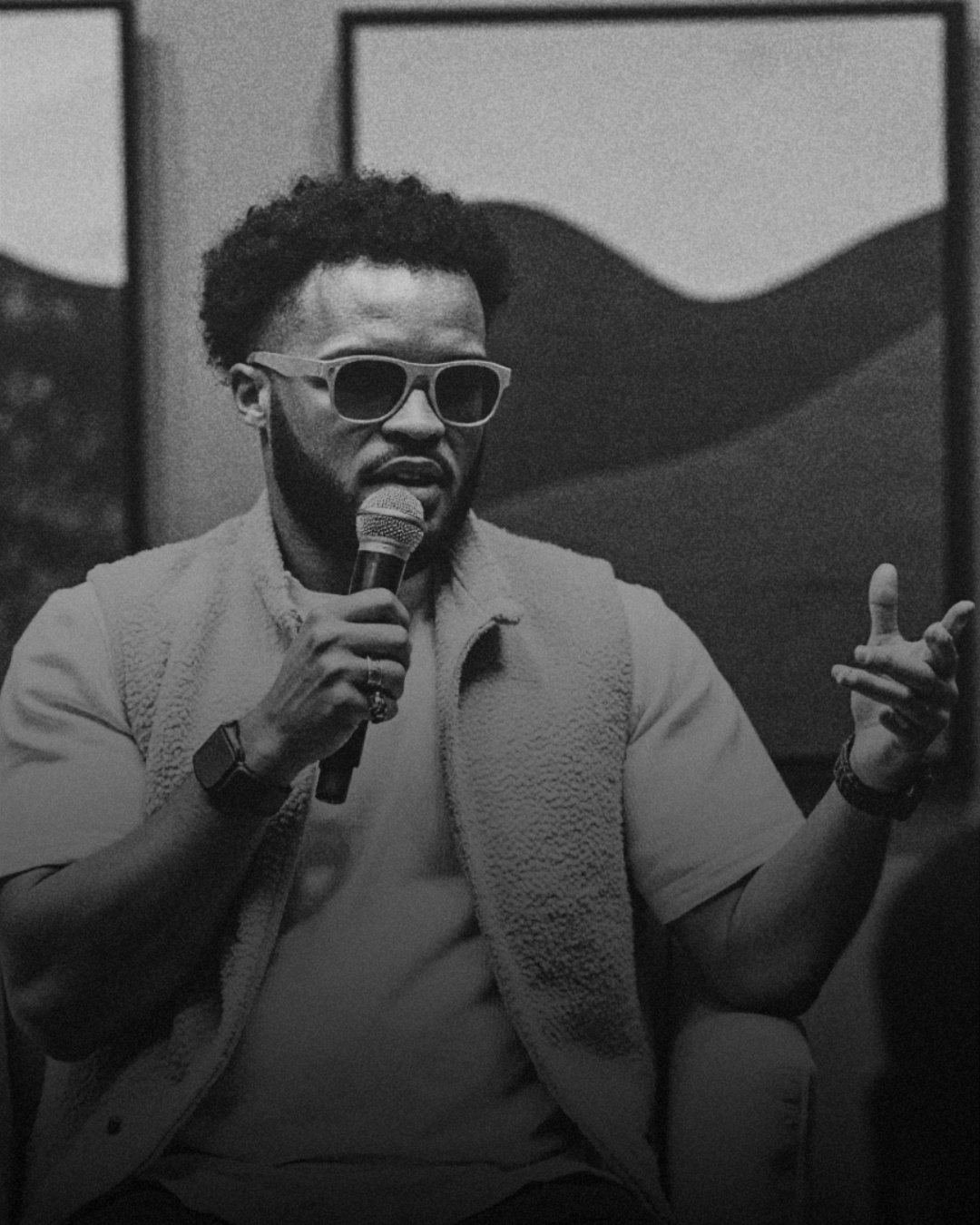Jared T. Ross speaking on a microphone