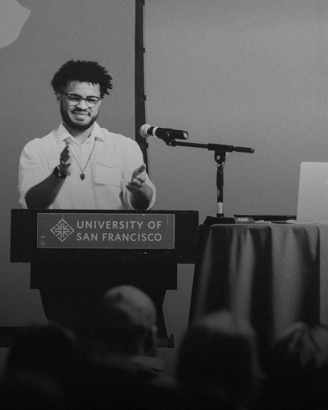 Jared T. Ross speaking at the University of San Francisco lectern